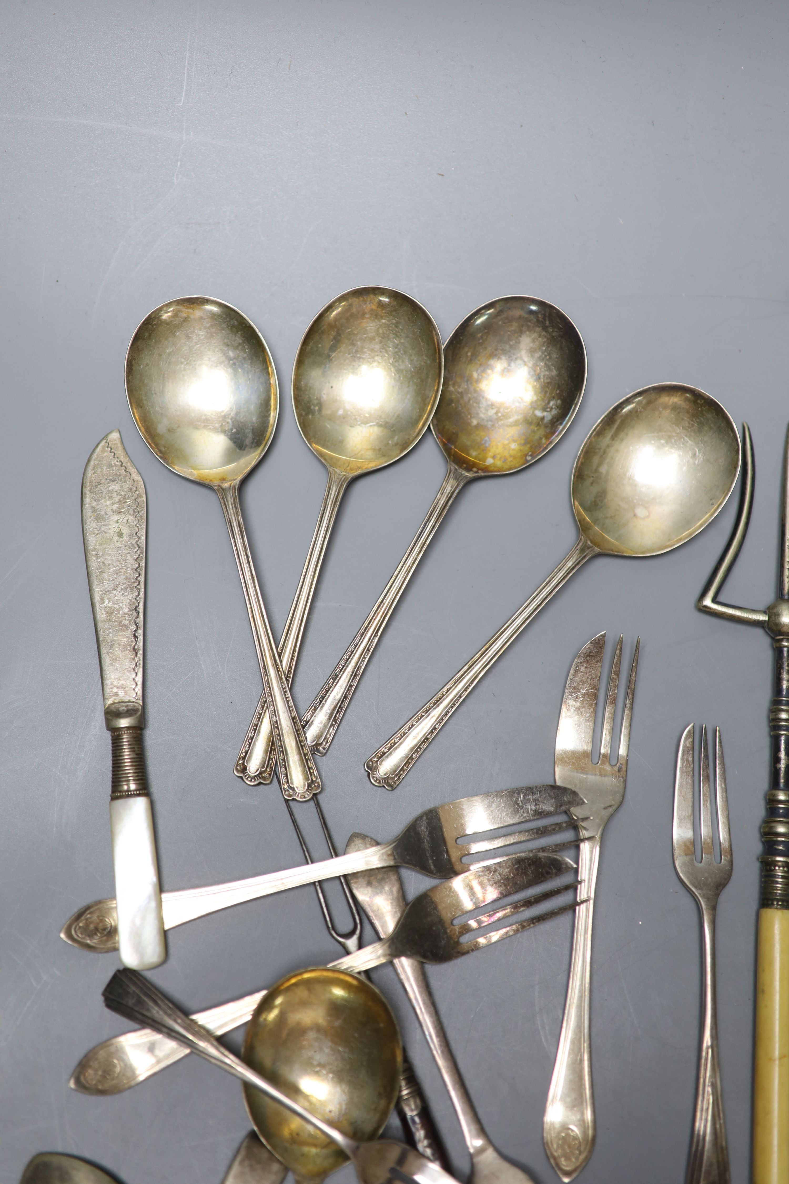 Two sets of silver spoons including bean end coffee spoons, six silver handled tea knives and a silver handled magnifyer etc.